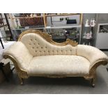 A gilded chaise longue.