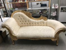 A gilded chaise longue.