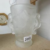 An art deco frosted glass vase decorate with fish and with 2 handles.