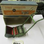 A boxed Dinky Super Toys lawn mower in good condition.