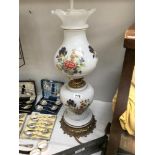 An overlaid floral glass oil lamp style electric table lamp