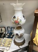 An overlaid floral glass oil lamp style electric table lamp