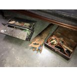 A metal toolbox with contents including 3 wood saws,