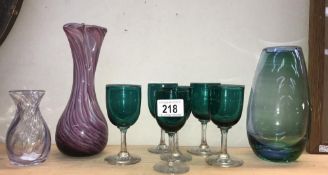 A quantity of coloured glass vases and drinking glasses