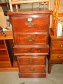 A pair of darkwood stained 2 drawer chests with brass handles