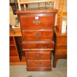 A pair of darkwood stained 2 drawer chests with brass handles