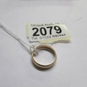 An unmarked 9ct gold wedding ring, size M (with receipt for remodelling 2 9ct gold rings in to one).