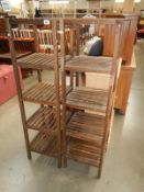 A pair of slatted wood bathroom shelves