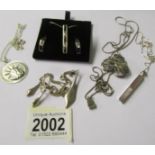 2 silver pendants with earrings sets and 3 silver pendants.