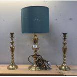 A pair of brass candlestick lamps and a brass table lamp