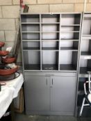 A storage cupboard with pigeon hole top