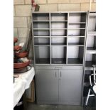 A storage cupboard with pigeon hole top