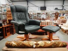 A green leather swivel chair with stool