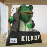 A 'Kilkof' advertising frog figure.