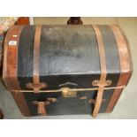 A domed leather trunk including upper compartment