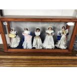 A display cabinet with 5 dolls as house maids