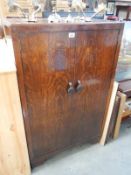 A 1930's oak gents bedroom cupboard with shelves