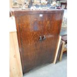 A 1930's oak gents bedroom cupboard with shelves