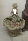 A garden bird bath surmounted with figure of Pan,.