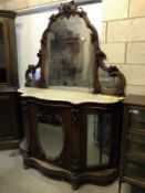 A Victorian mahogany mirror back credenza with marble top, carvings of berries and leaves,