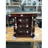 A red lacquered 3 drawer side cabinet with glass top