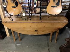 A large oval pine drop leaf table
