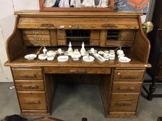 An oak roll top / tambour office desk