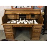 An oak roll top / tambour office desk