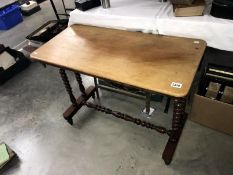 A mahogany side table on stretcher base
