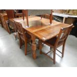 A 1930's oak draw leaf table and 4 chairs