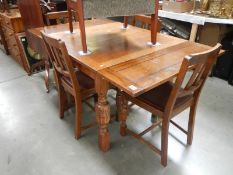 A 1930's oak draw leaf table and 4 chairs