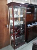 A darkwood stained glazed display cabinet