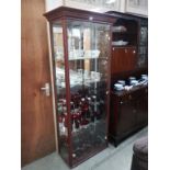 A darkwood stained glazed display cabinet