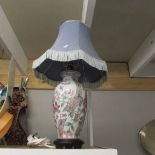 A pair of oriental style table lamps with shades.