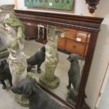 A mahogany framed over mantel mirror with double bevel edge.