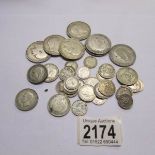 A mixed lot of silver coins including half crowns, shillings, sixpences and threepences,