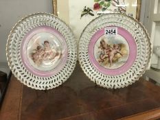 2 unmarked cabinet ribbon plates featuring cherubs