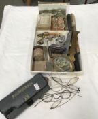 A box of miscellaneous collectables including WW1 brass button cleaners, vintage spectacles,