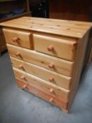 A modern solid pine chest of drawers