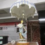 A figural style table lamp with shade.