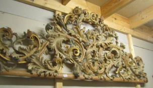 An ornate carved headboard.