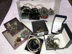 A quantity of assorted costume jewellery including silver ear studs, charm bracelet etc.