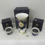A Royal Worcester vase and 2 Royal Worcester candle holders with candles, all boxed.