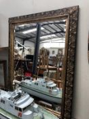 A large ornate framed bevel-edge mirror. Approximately 47.25 x 37.