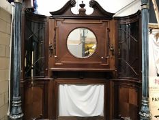 A magnificent mahogany fire surround with over mantle mirror and side cabinets