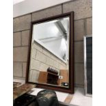 A framed bevel edged mirror