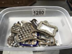 A quantity of vintage costume jewellery including enamel buckle, hair slides etc.