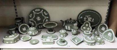 A collection of Wedgwood green Jasperware including teapot A/F, plates, pin dishes etc.