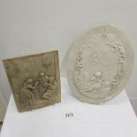 An oval plaque depicting cherubs and one other.