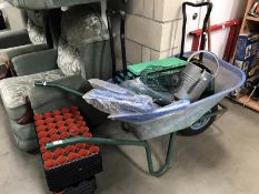 A wheelbarrow and gardening items